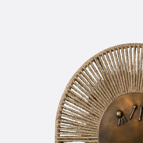 Sun-inspired bronze wall lamp with ropes