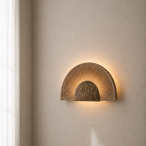 Sun-inspired bronze wall lamp with ropes