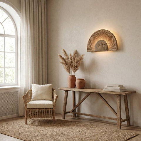 Sun-inspired bronze wall lamp with ropes